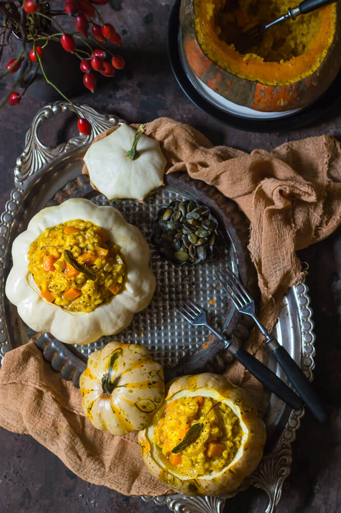 Brown rice risotto with pumpkin and sage served in baked squashes