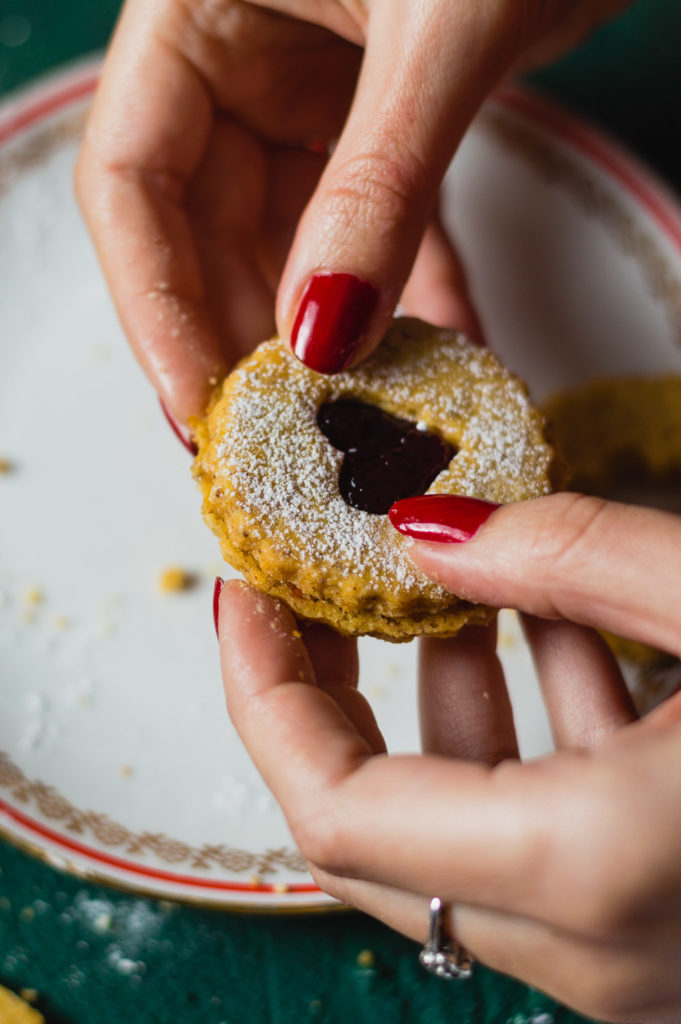 A woman hands assembling Linzer Christmas cookies