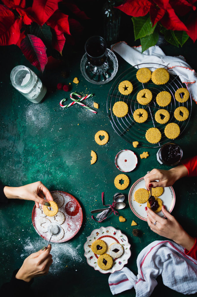 Two young women making Christmas Linzer cookies 