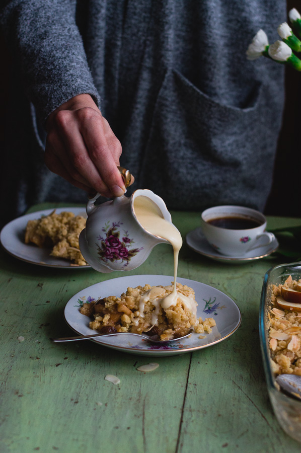 cardamom butter sauce being poured over apple crumble