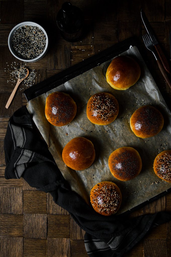 fresh out of the oven brioche burger buns with sesame and poppy seeds