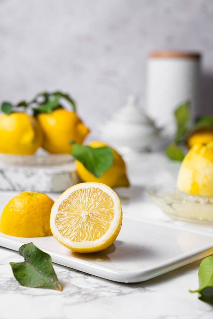 organic lemon cut in half, ready to be juiced