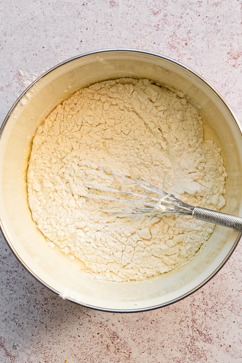 adding flour to pancake batter