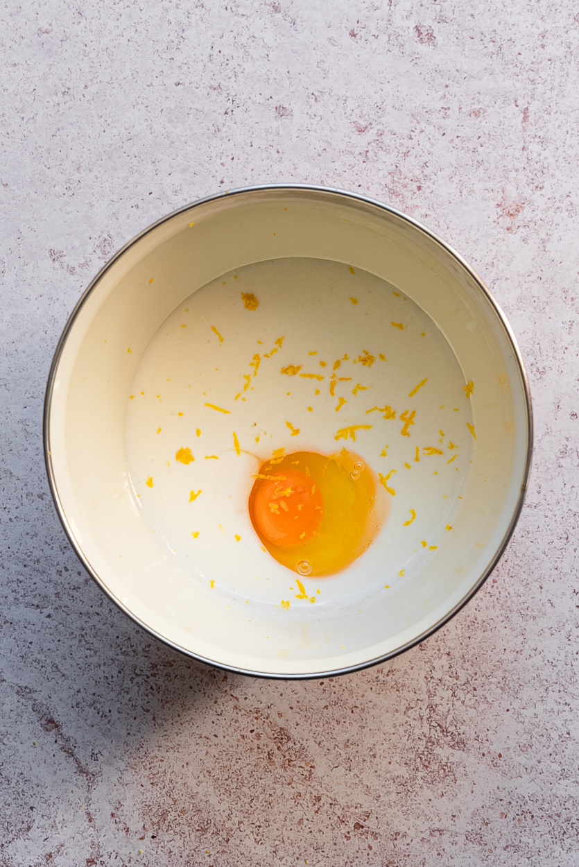 kefir, an egg and lemon zest in a bowl
