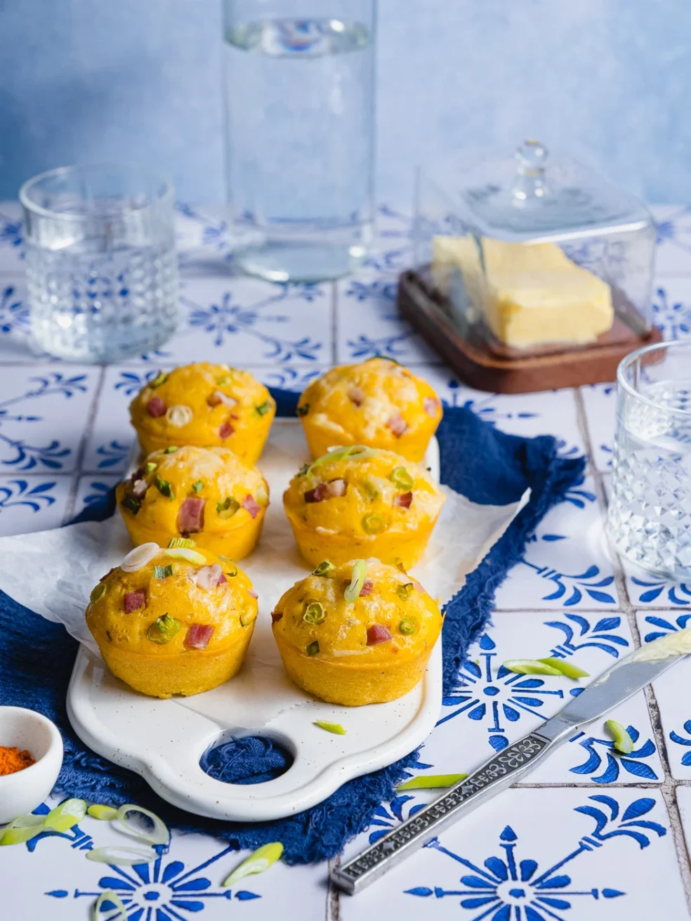 savory ham and cheese cornbread muffins served on a white ceramic board