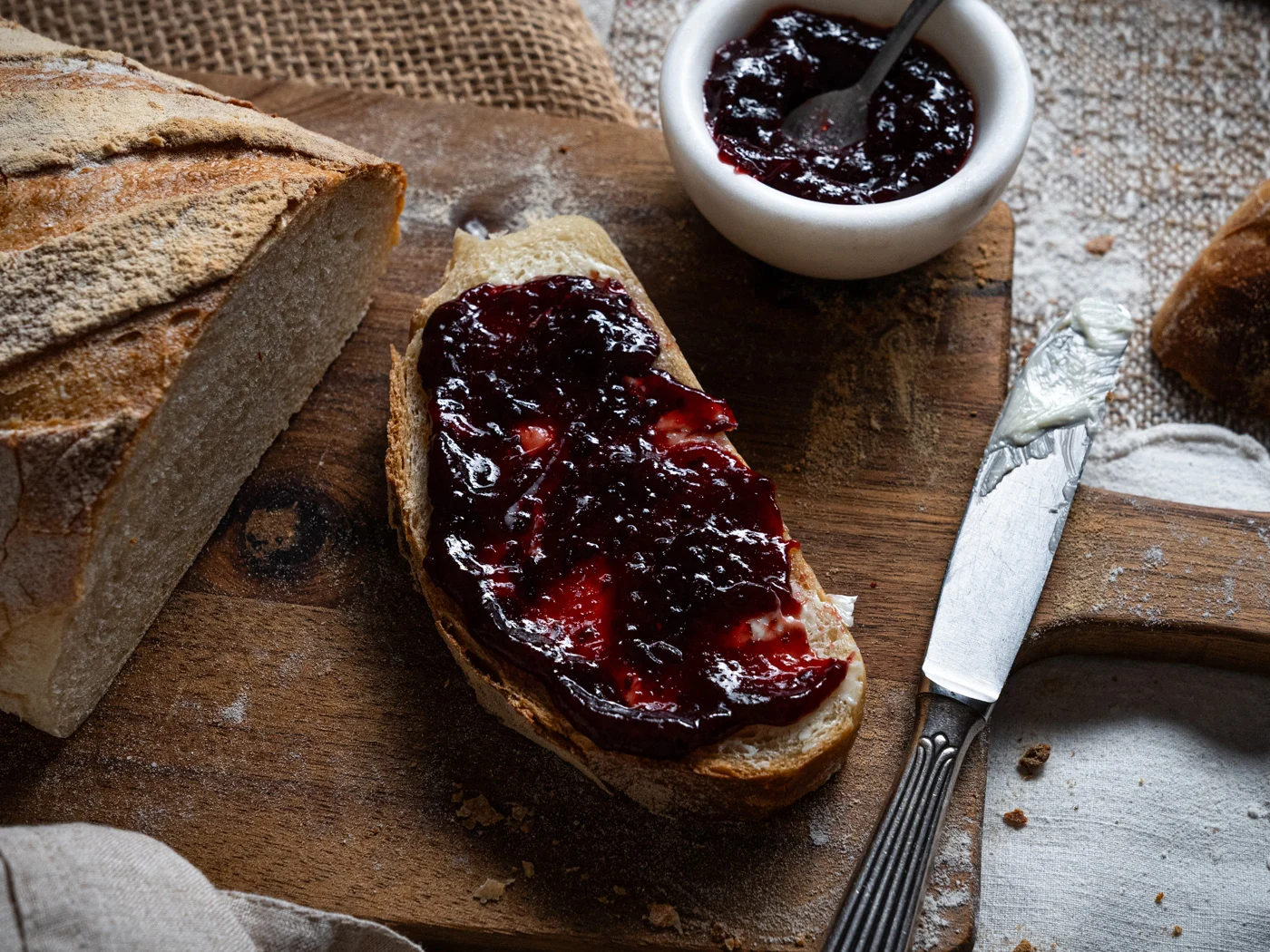 a slice of bread with butter and plum jam