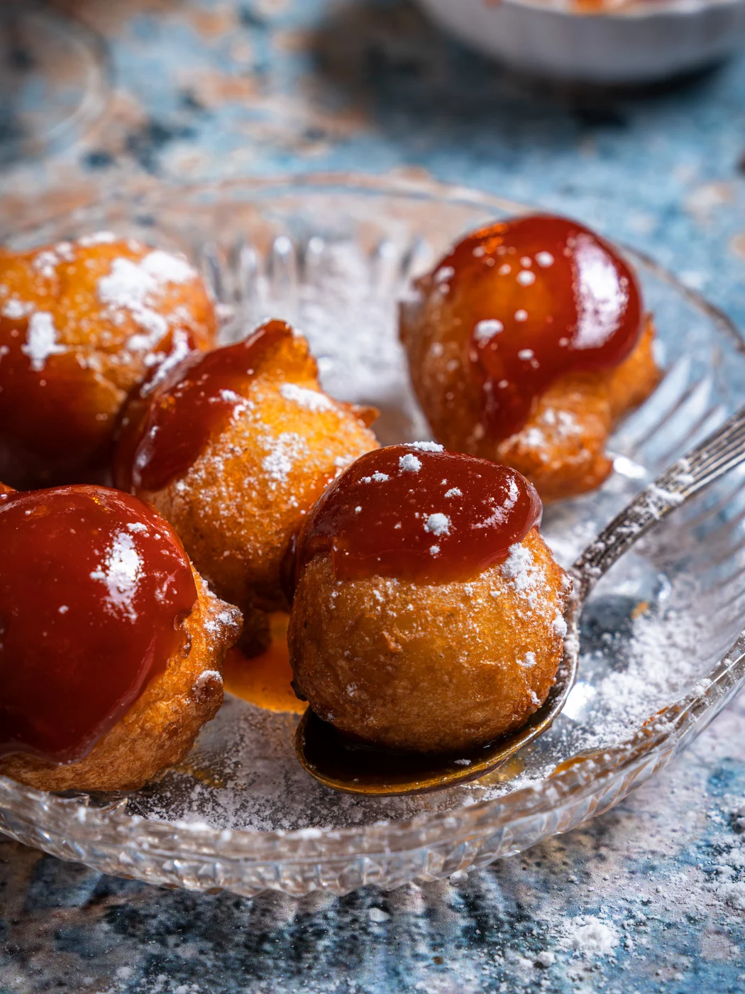 croatian fritule (sweet mini fried ball doughs) covered with rosehip jam