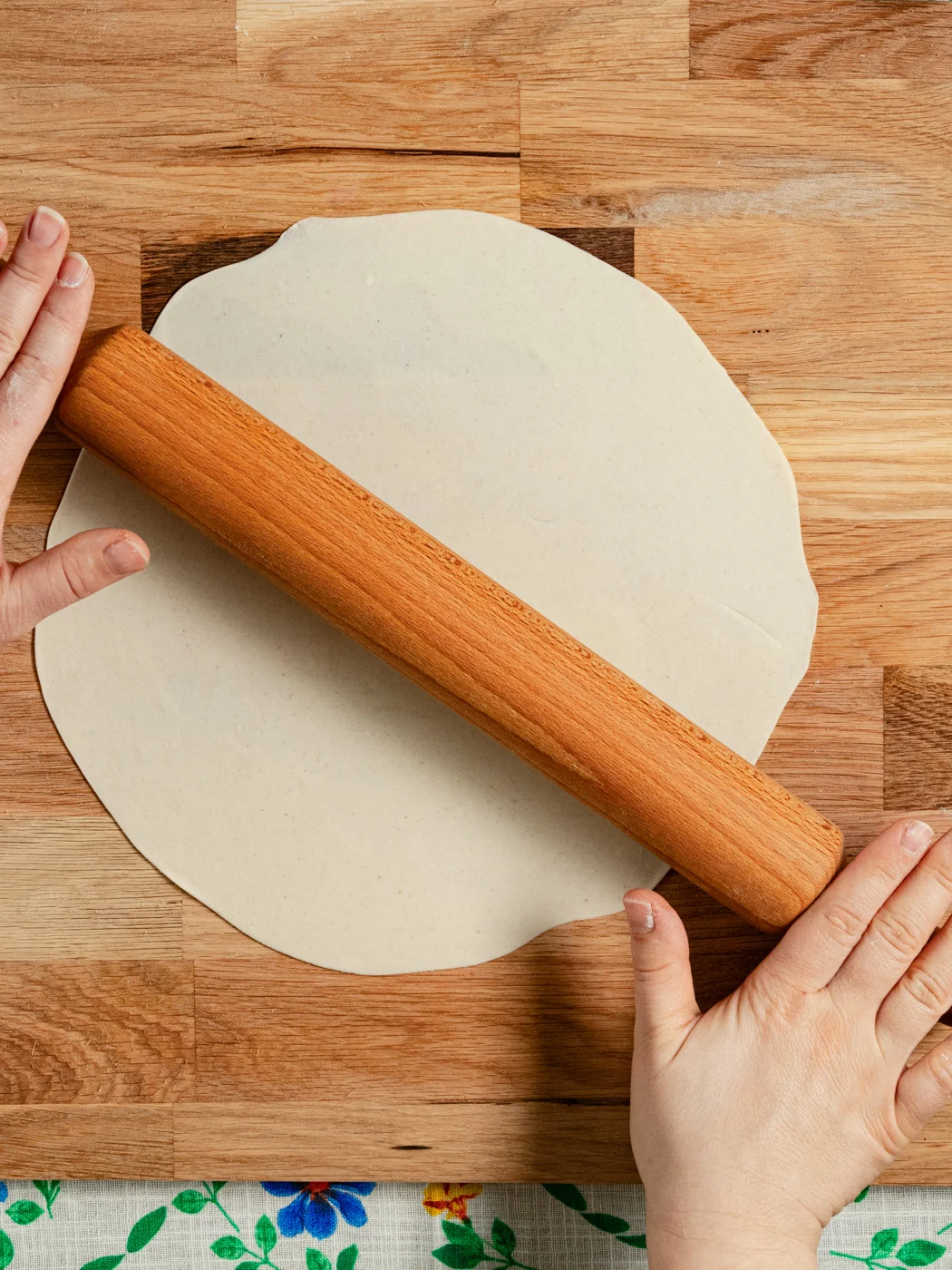 rolling the tortilla dough with rolling pin