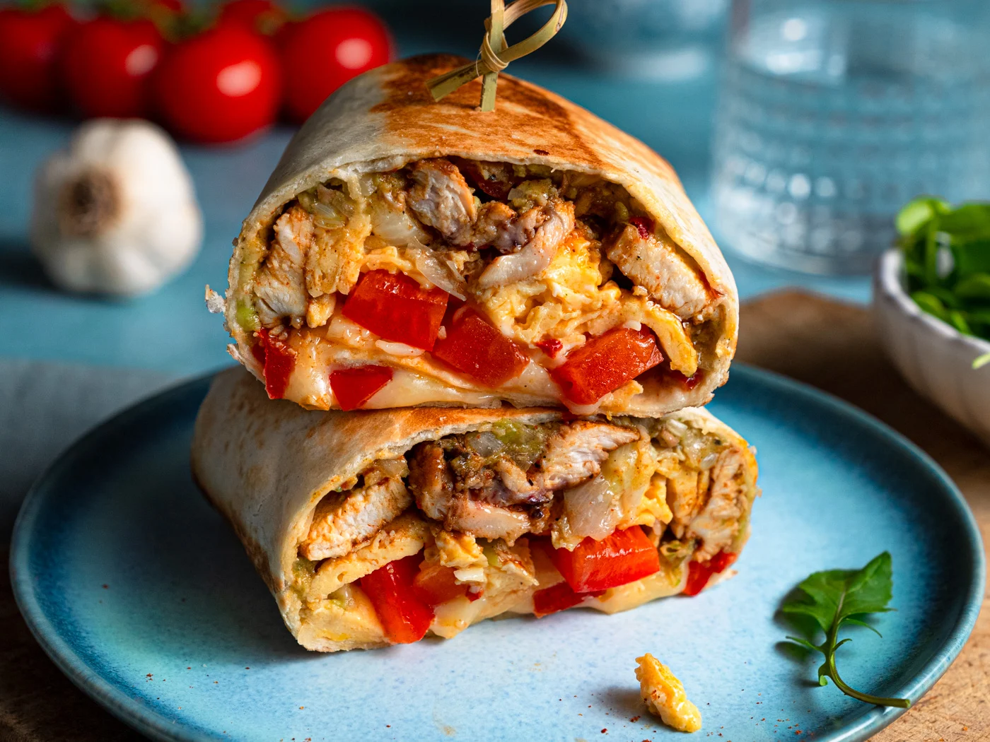 high protein breakfast burritos served on a blue plate, great for meal prep