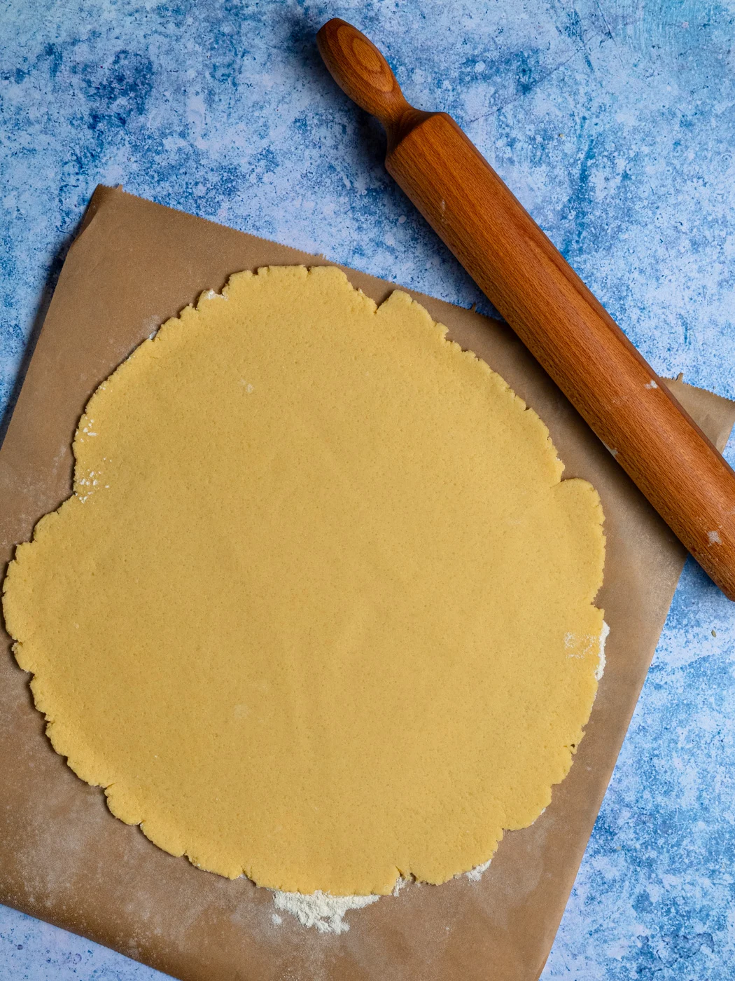 rolled shortcrust pastry on a piece of parchment paper