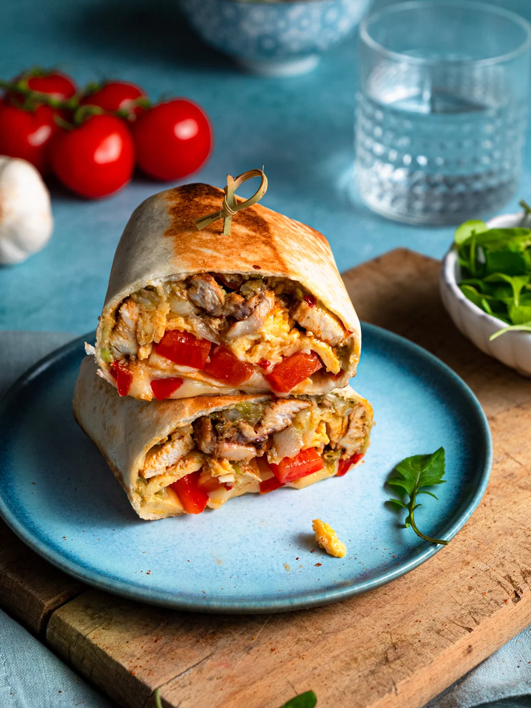 high protein breakfast burrito, cut in half and served on blue plate