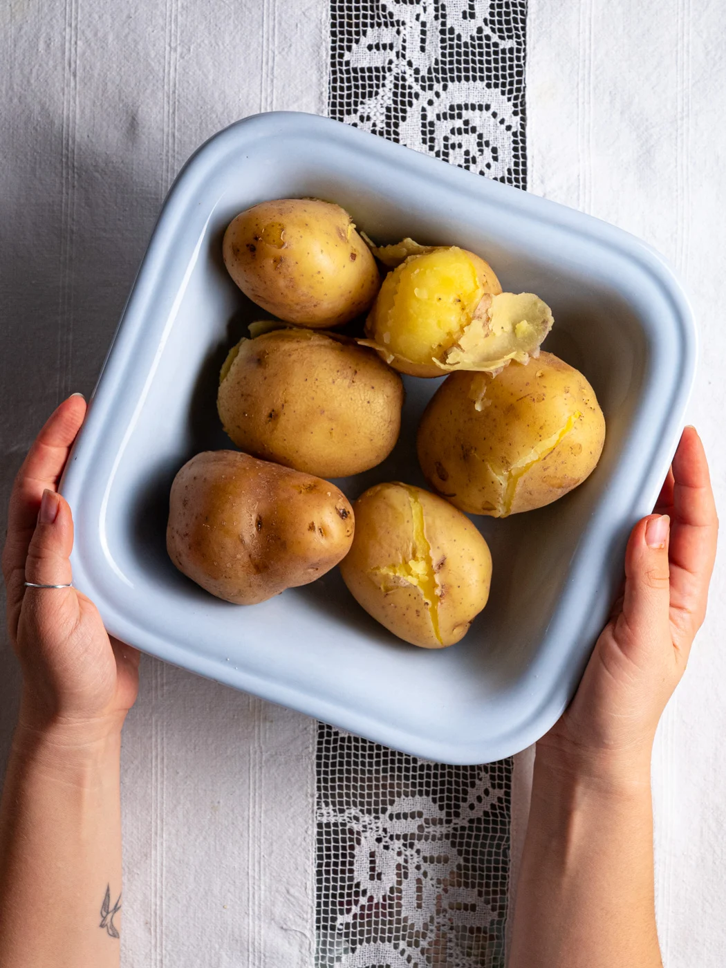 cooked yellow potatoes with skin on, ready to be mashed