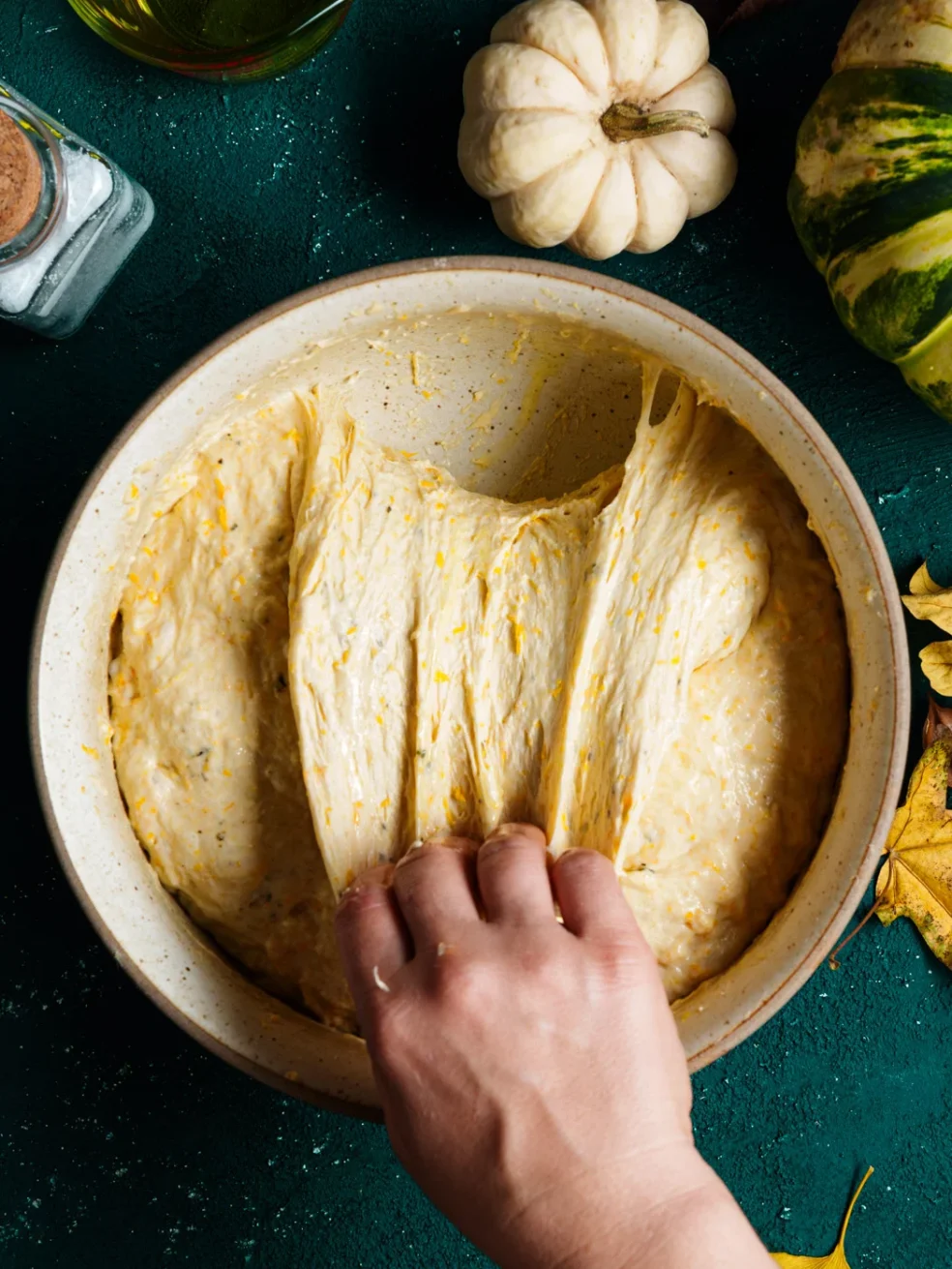 performing stretch & fold on pumpkin focaccia dough