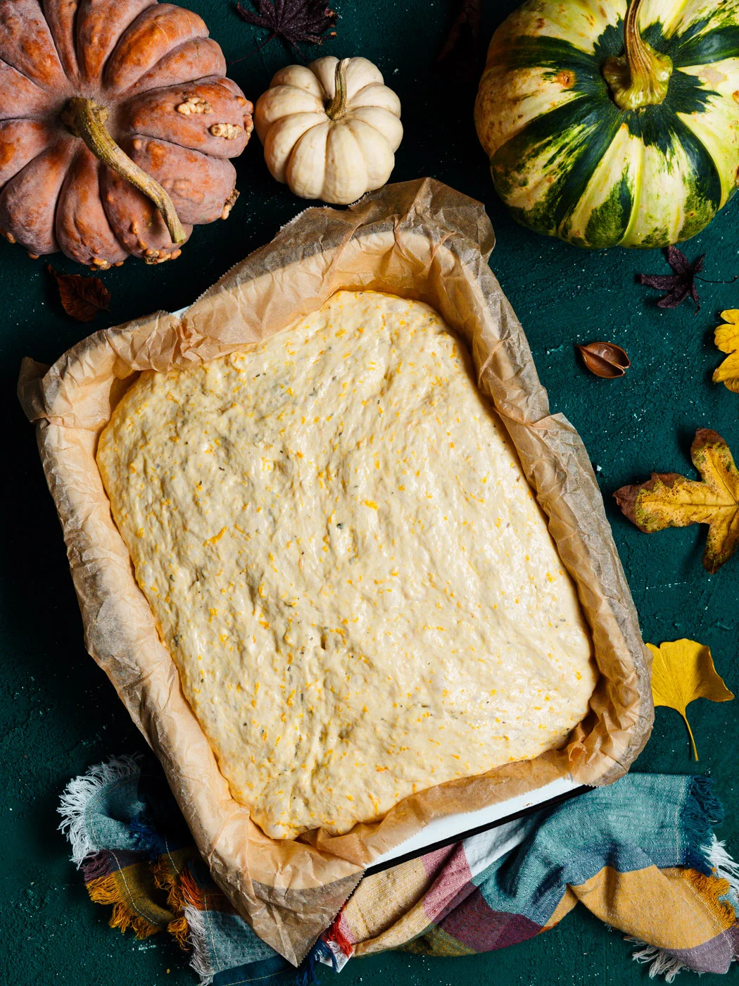no-knead pumpkin focaccia dough in a baking tray
