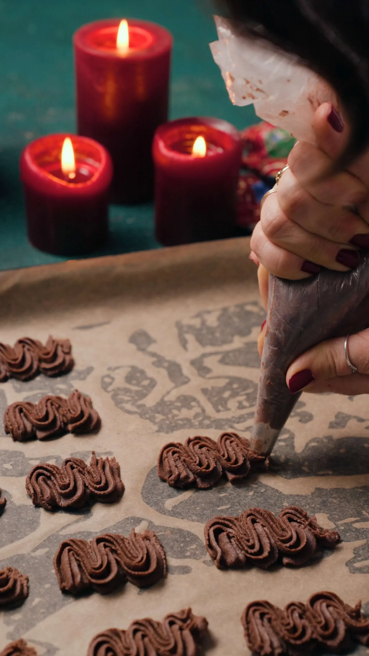 piping chocolate viennese whirls on the baking tray