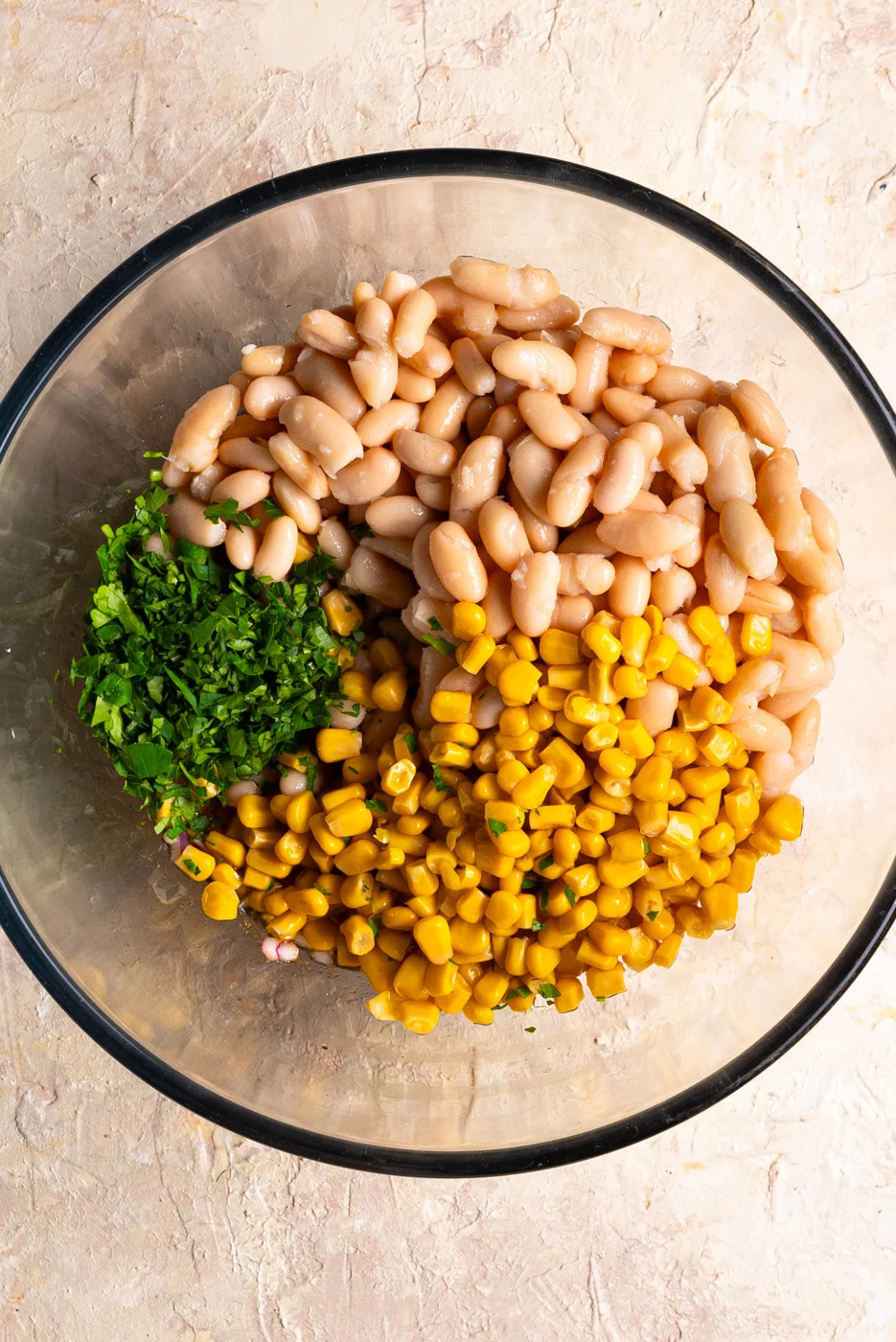 white beans, chopped parsley, and corn added to a big bowl